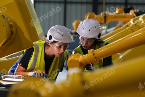 Preview: Robotics engineer working on maintenance of robotic arm in factory warehouse. Business technology.