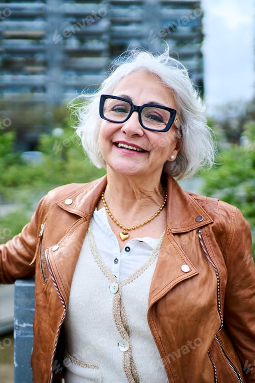 Preview: Portrait of a Healthy Happy Caucasian Senior Woman with Gray Hair Standing Outside at city