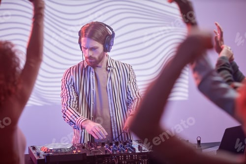 Preview: Long haired DJ by turntable in neon lights
