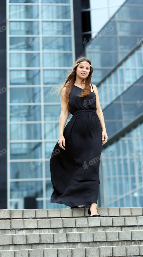 Preview: Woman in black dress on the street