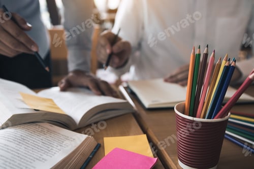 Preview: Teenage student works on homework in his room and writing in notebook.