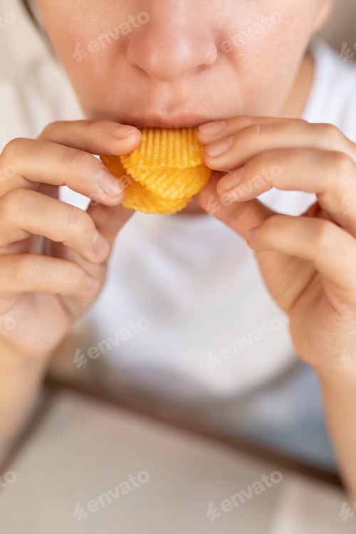 Preview: woman eating potato chips for snack