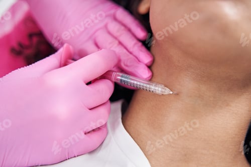 Preview: Young female neck is injected with small syringe with drug