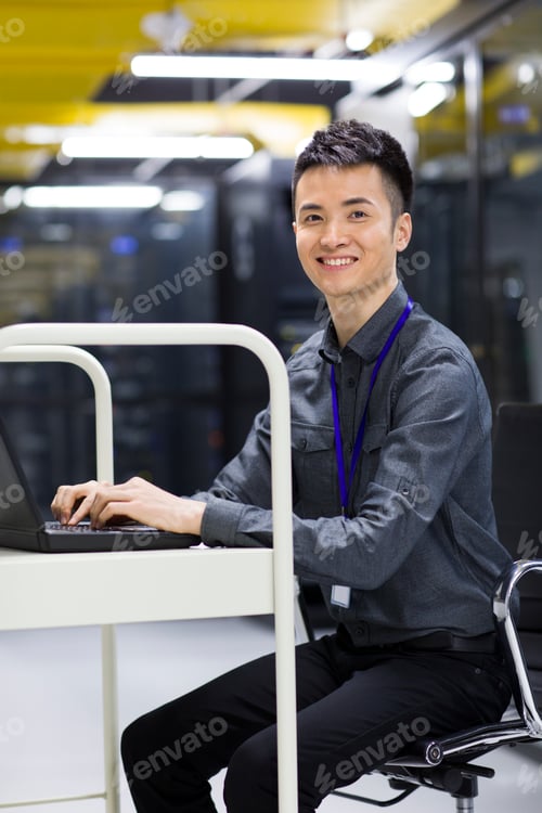 Preview: Businessman using laptop in computer room