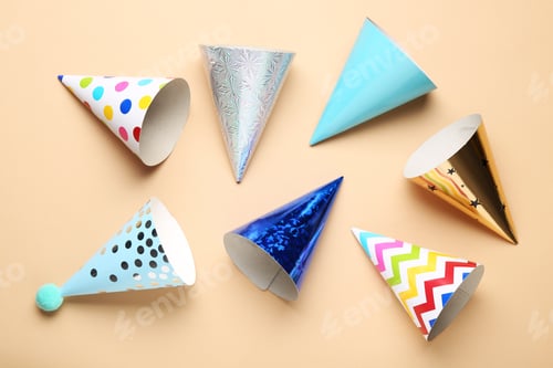 Preview: Colorful party hats on beige background, flat lay