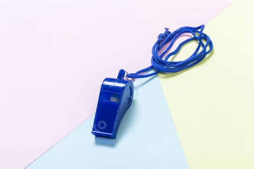 Preview: Whistle on a colored background with a blue cord ready for use in sports or events