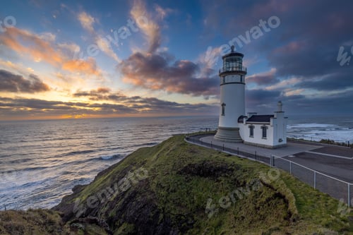 Preview: Beautiful shot of the North Head Lighthouse on a hill at sunset in Ilwaco, Washington