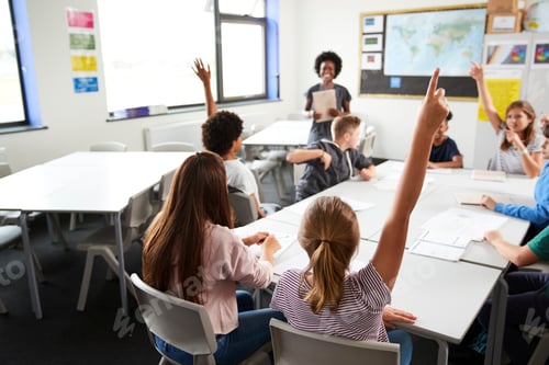 Preview: High School Students Raising Hands To Answer Question Set By Teacher In Classroom