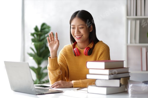 Preview: Happy girl learning and reading in the library.