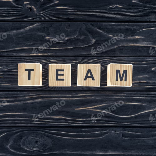 Preview: top view of word team made of wooden blocks on dark wooden tabletop