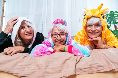 Preview: Beautiful senior women having funny pajama party at home