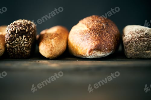 Preview: Different types of bread loaves close up with copy space