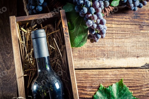Preview: Tasty red wine in wooden box on old wooden table