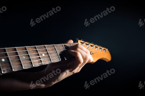 Preview: Musician playing the electric guitar. Close-up of a man's hand playing the Am chord. Guitar