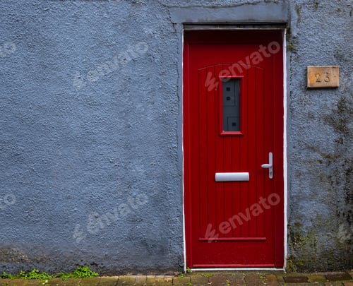 Preview: Traditional English house facade front entrance with red closed door .