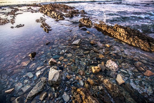Preview: Nature, environment and ocean with rock at beach for sunset, calm and seascape. Natural scenery, wav