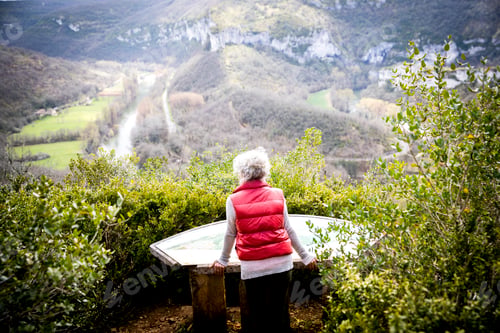 Preview: Woman on viewpoint looking at map, Bruniquel, France