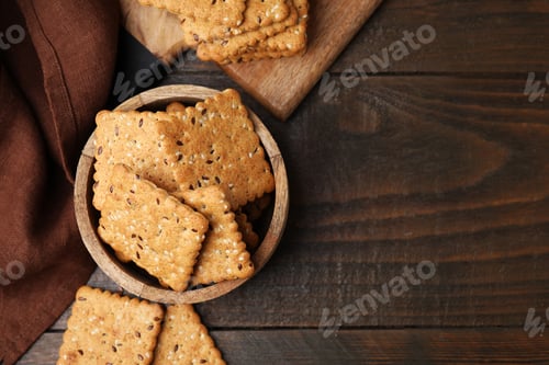 Preview: Cereal crackers with flax and sesame seeds on wooden table, flat lay. Space for text