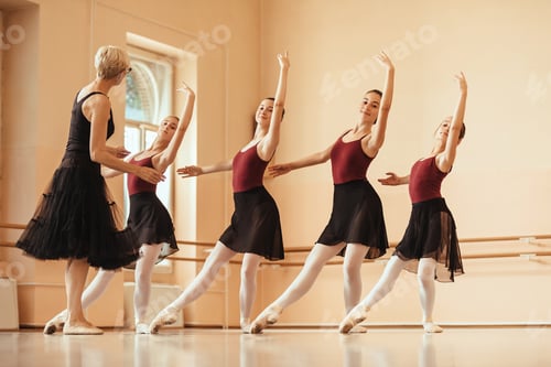Preview: Group of ballerinas practicing with their teacher at ballet studio.