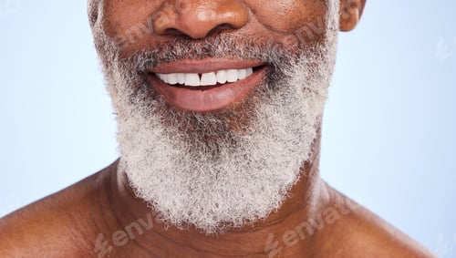 Preview: Cropped shot of a mature man smiling while posing against a blue background