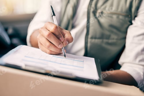 Preview: Shot of a delivery man writing on a clipboard while sitting in his vehicle