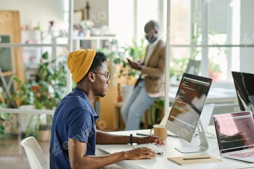 Preview: African man writing code on new software