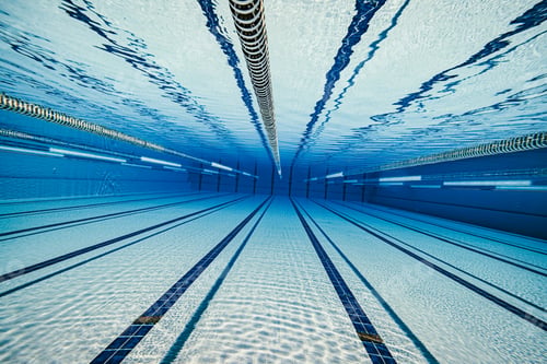 Preview: Olympic Swimming pool under water background.