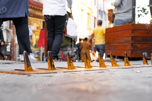 Preview: Close-up of yellow spikes for a tire puncture for stopping the car in a street of Istanbul