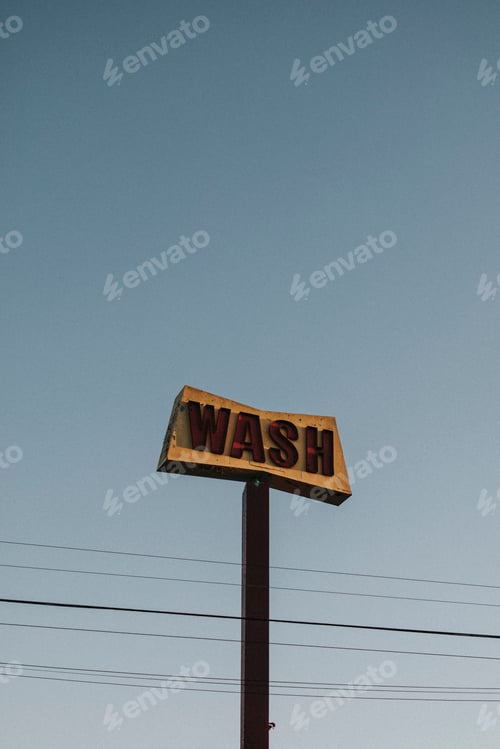 Preview: Old rustic car wash sign in the blue sky