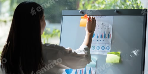 Preview: Business women holding a darts aiming at the target center business goal concept business target