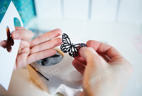 Preview: The right tools for crafting. Cropped shot of a womans hands holding a punched out paper butterfly.