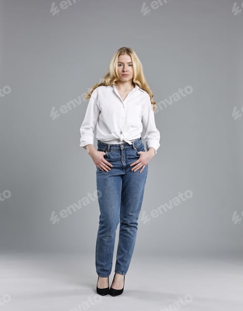 Preview: Beautiful young woman in stylish jeans on grey background