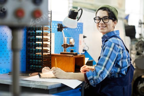 Preview: Watchmaker examining calculations at workplace