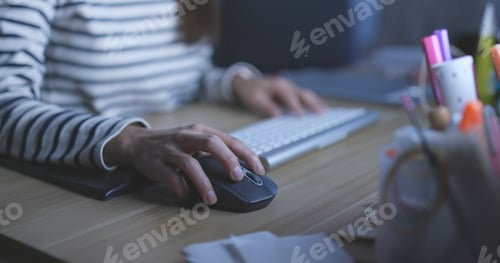 Preview: Woman working on computer at night