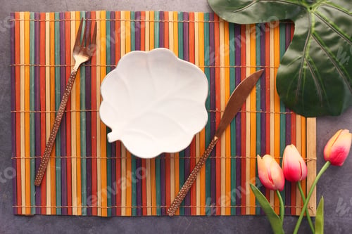 Preview: cutlery and empty plate on wooden background top down