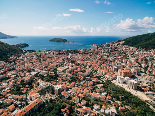 Preview: View over the red roofs of multi-storey buildings to the sea and green mountains. Budva, Montenegro