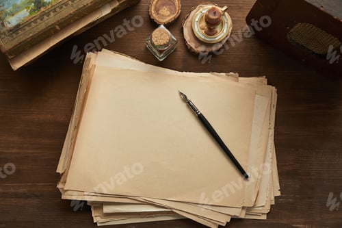 Preview: top view of vintage paper, painting, fountain pen and old radio on wooden table