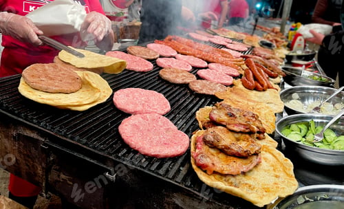 Preview: Serbian cuisine grilled burger patties and tortillas sausages chicken and salads on bbq grill
