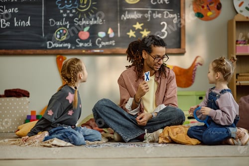 Preview: Girls and Black Man Teacher Engaging in Learning Activity at Kindergarten