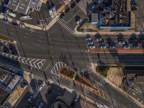 Preview: Aerial view of a busy urban intersection with vehicles.