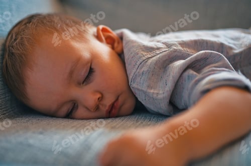 Preview: Cute little boy sleeping on couch