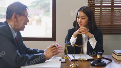 Preview: Legal and justice concept, Senior lawyer explains and provide legal advice to young female lawyer