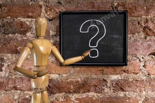 Preview: Wooden mannequin showing a question mark on chalkboard, blackboard over a brick wall background
