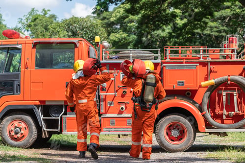 Preview: Firefighters keep rubber fire hoses while training using spraying high pressure water from hoses