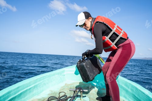 Preview: Marine biologist working on a boat on the sea