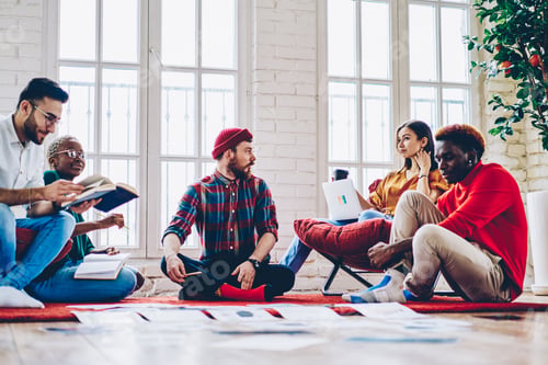 Preview: Diverse group of skilled students communicating during involved briefing