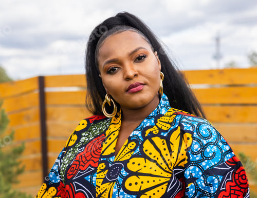 Preview: Summer portrait of beautiful african american woman in colourful dress wear standing on backyard