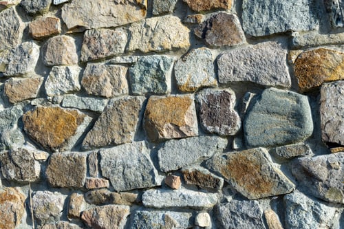 Preview: Background from a wall with stones in sunlight