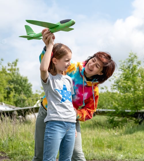 Preview: Mother and daughter playing with toy plane