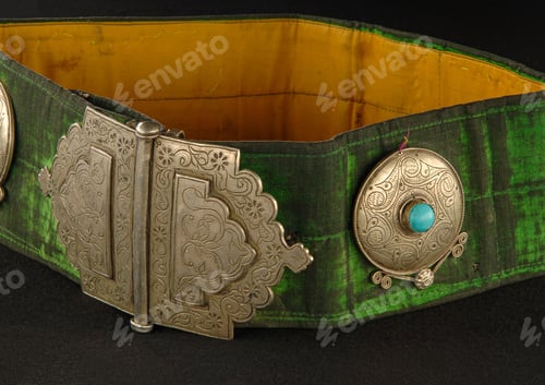 Preview: Green, antique belt with precious stones isolated on a black background